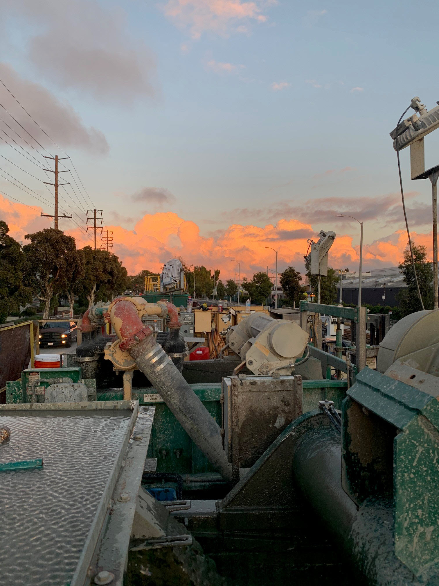 Pipes, mud tank and shaker screens used during groundwater well drilling