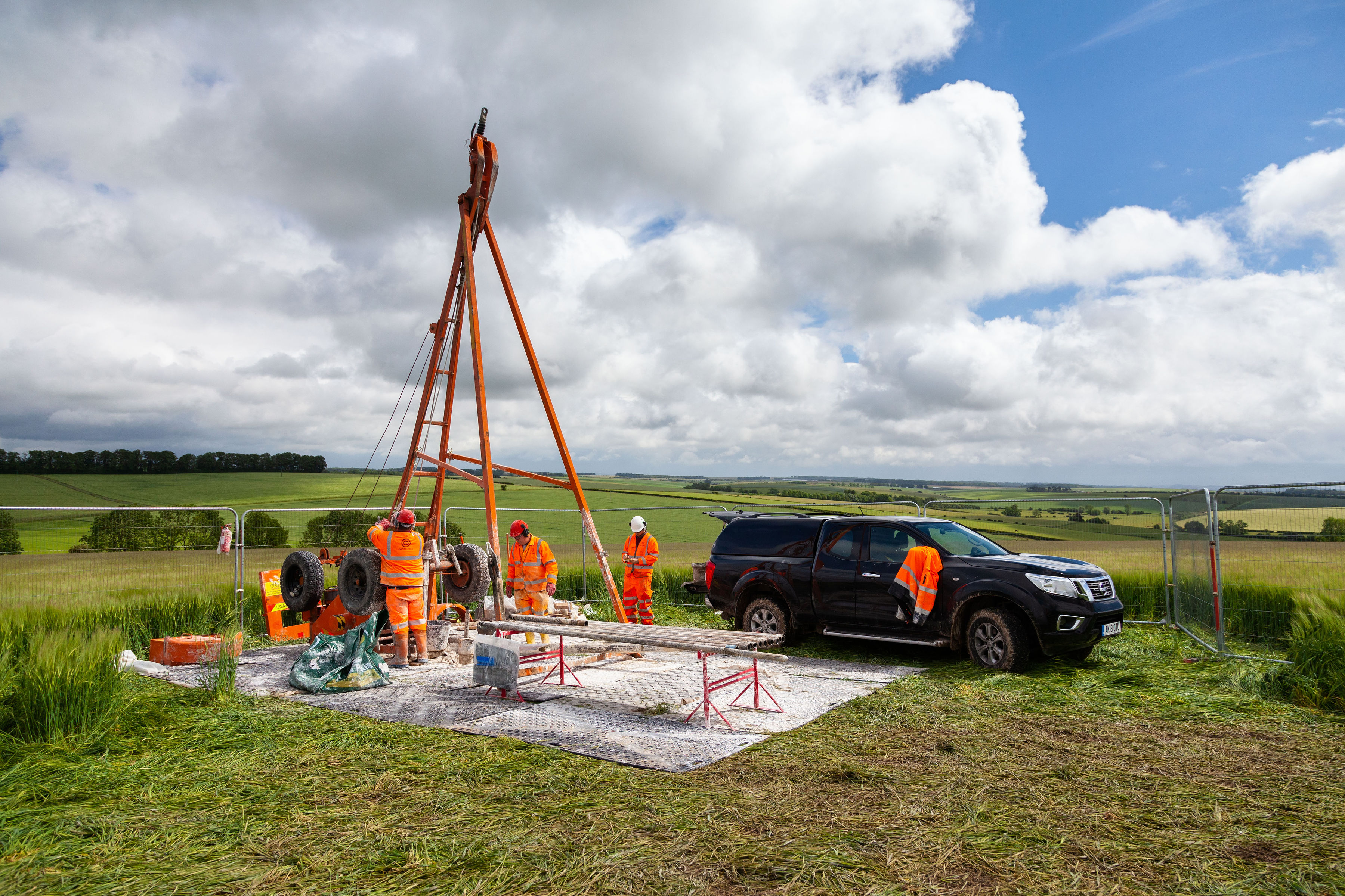 Ground investigation crew and cable percussion rig working in open countryside