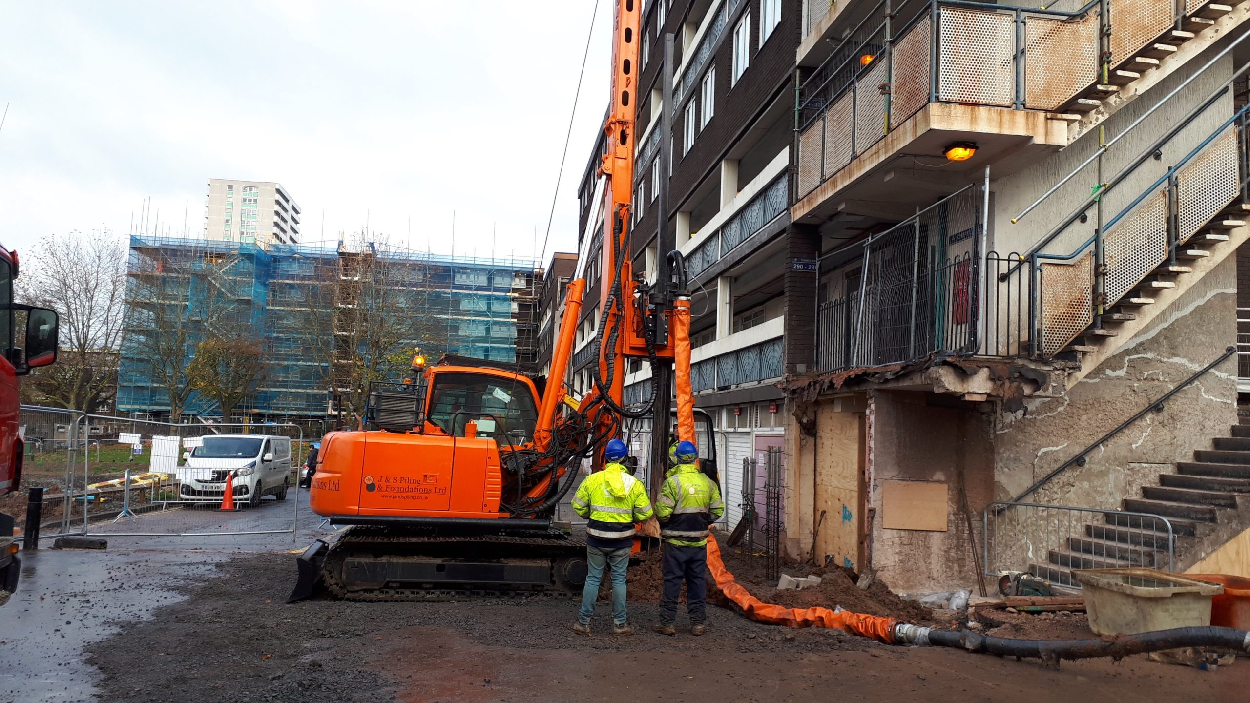 Piling crew working beside a CFA bored piling rig at a construction site